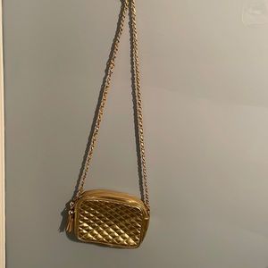 Vintage 1989 gold purse with long chain and tassels.